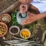 Man grinding Ayurvedic herbs