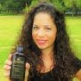 Shana holding 6 oz. Darshana hair oil bottle