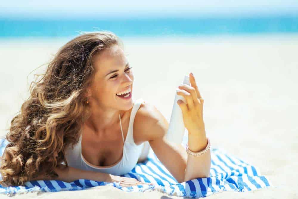 Girl on the beach with curly summer hair